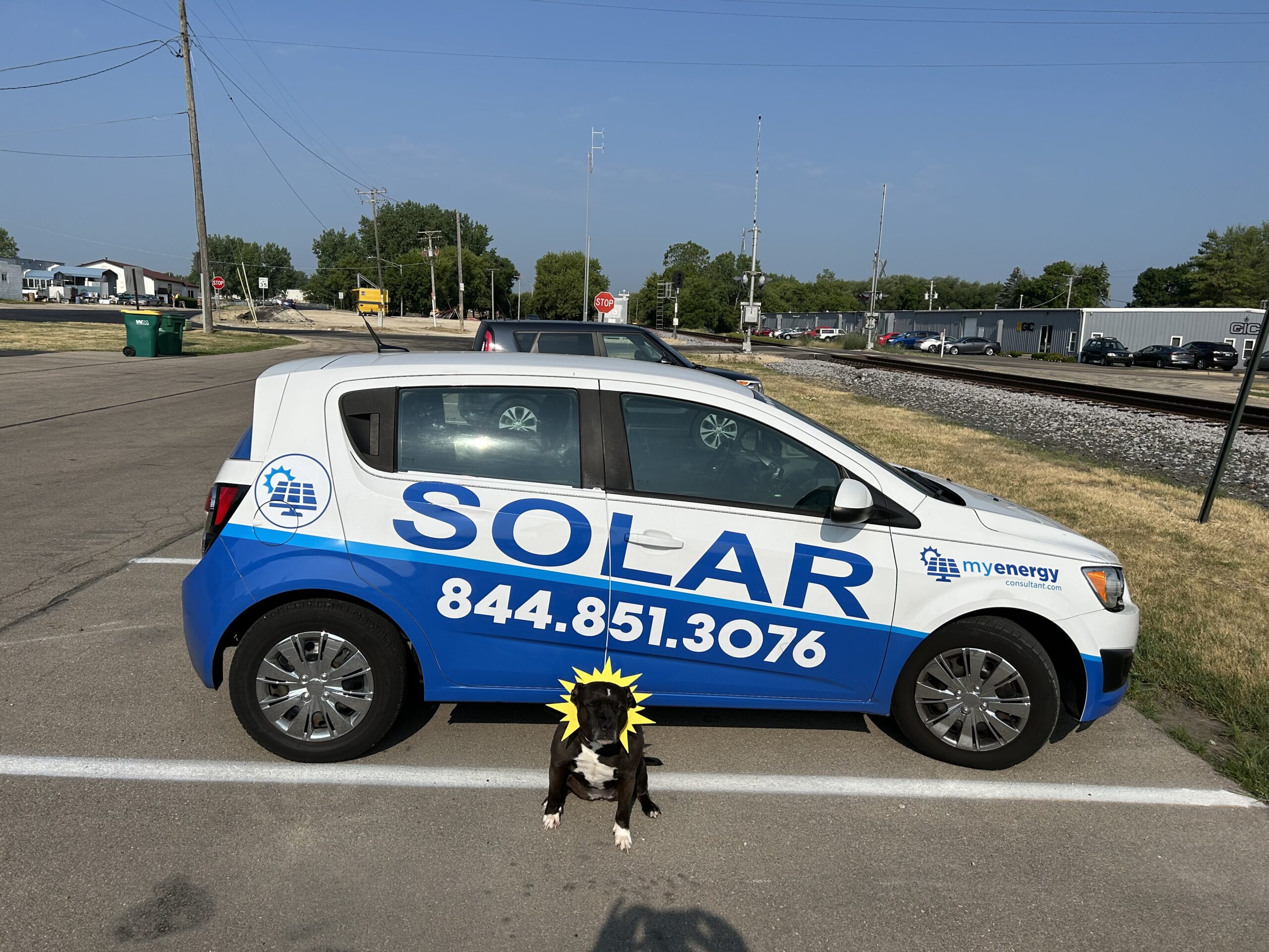 Nelly the sundog next to the myenergyconsultant.com wrapped car